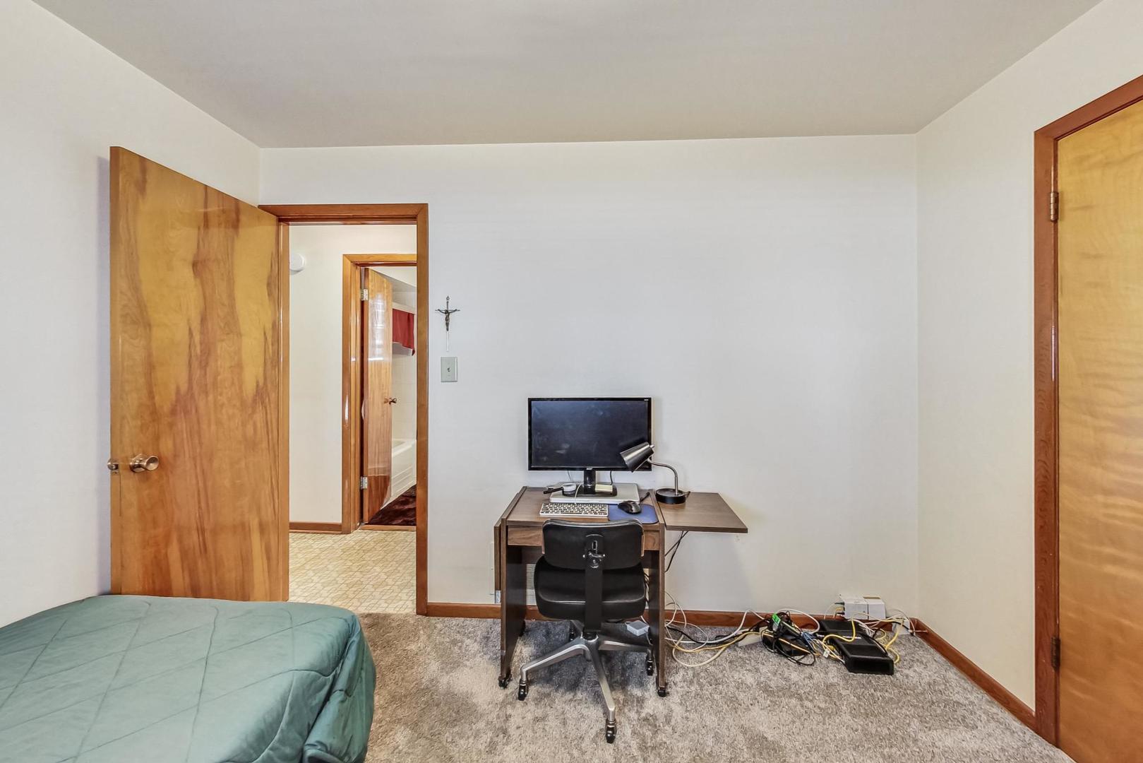 6241 South Rutherford Avenue Chicago, IL 60638 - Photo 16 of 39 a bedroom with a bed and a window