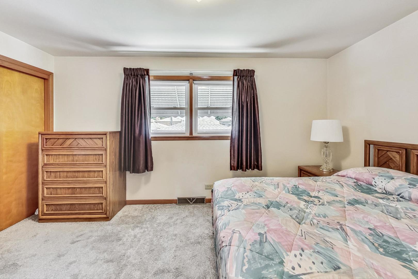 6241 South Rutherford Avenue Chicago, IL 60638 - Photo 19 of 39 a bedroom with a bed and a window