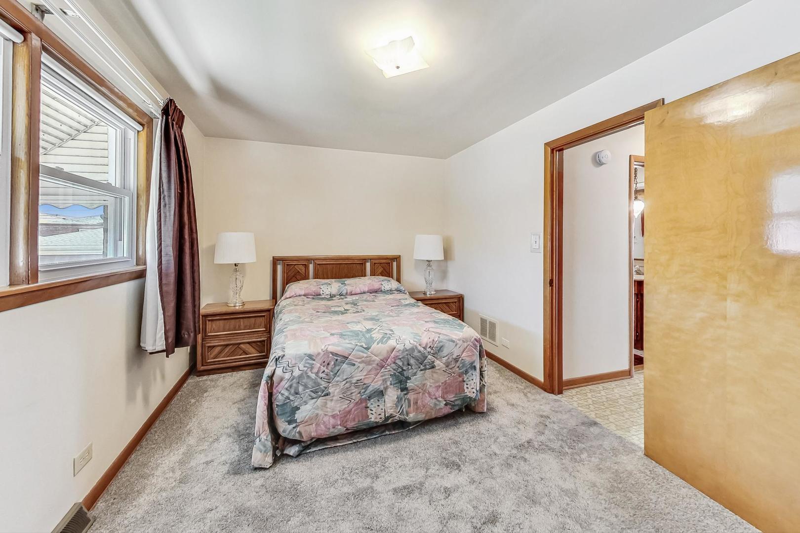 6241 South Rutherford Avenue Chicago, IL 60638 - Photo 20 of 39 a bedroom with a bed and a cabinets