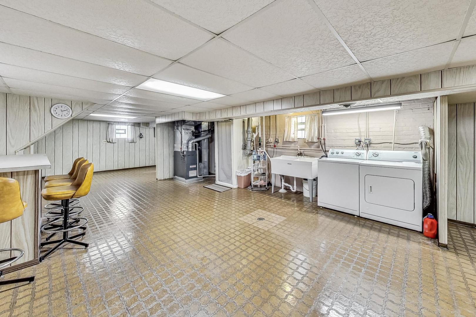 6241 South Rutherford Avenue Chicago, IL 60638 - Photo 22 of 39 a large white kitchen with a sink and cabinets