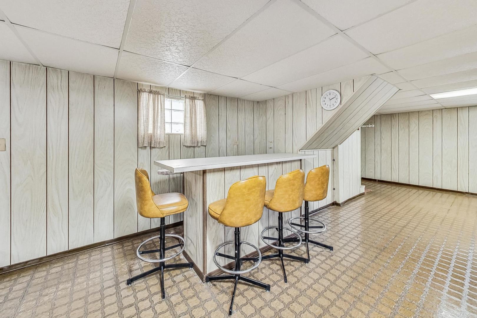 6241 South Rutherford Avenue Chicago, IL 60638 - Photo 25 of 39 a chair and table in a room with wooden floor