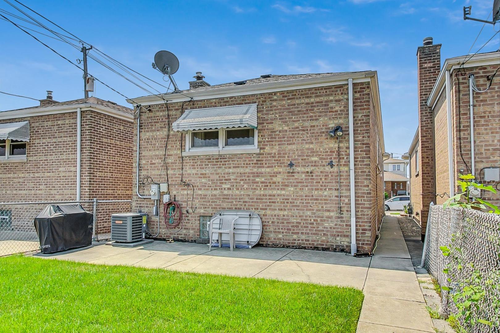 6241 South Rutherford Avenue Chicago, IL 60638 - Photo 28 of 39 a front view of a house with a yard