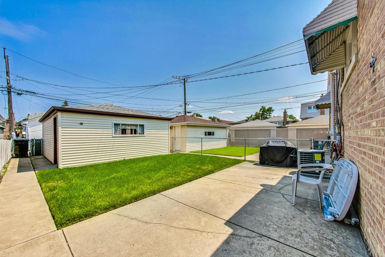 6241 South Rutherford Avenue Chicago, IL 60638 - Photo 32 of 39 a view of a backyard with plants and a patio
