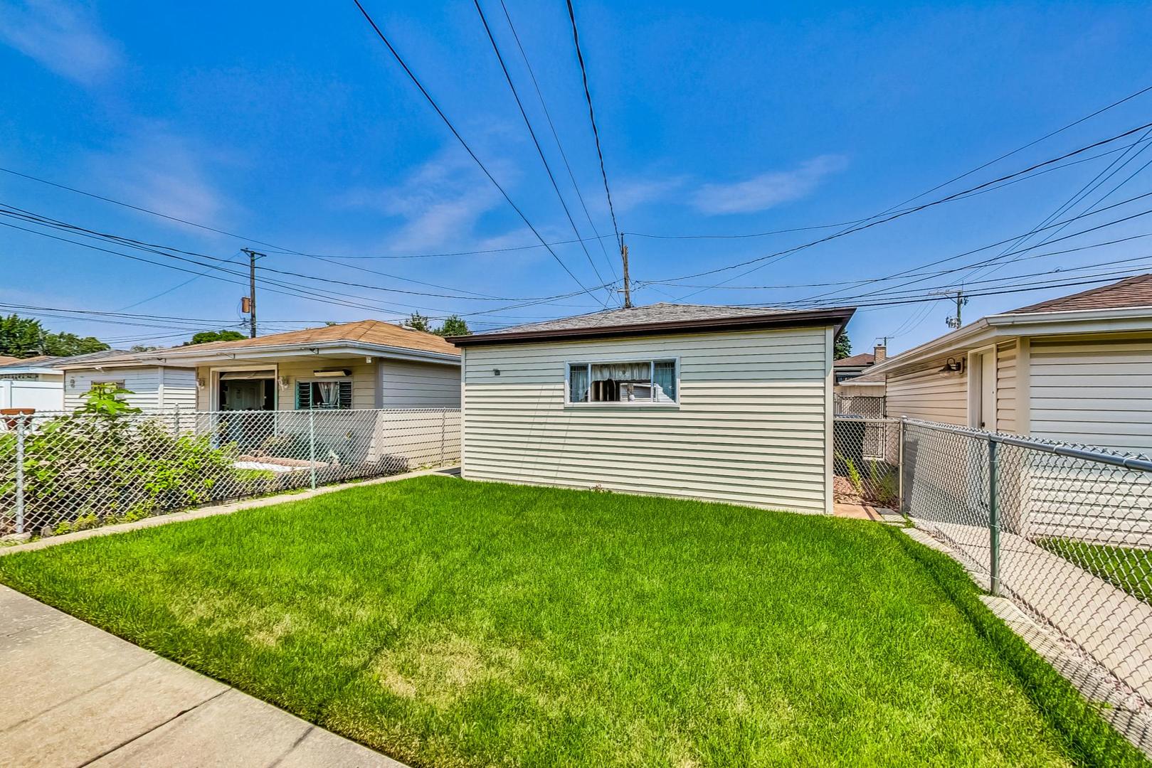 6241 South Rutherford Avenue Chicago, IL 60638 - Photo 33 of 39 a front view of a house with a yard