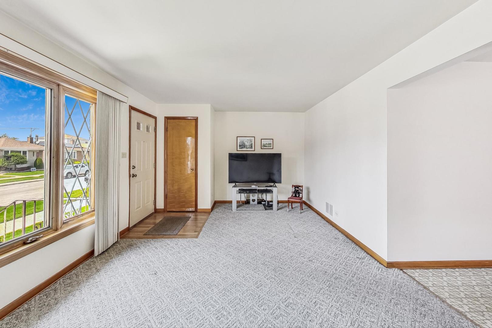 6241 South Rutherford Avenue Chicago, IL 60638 - Photo 5 of 39 an empty room with furniture and a window