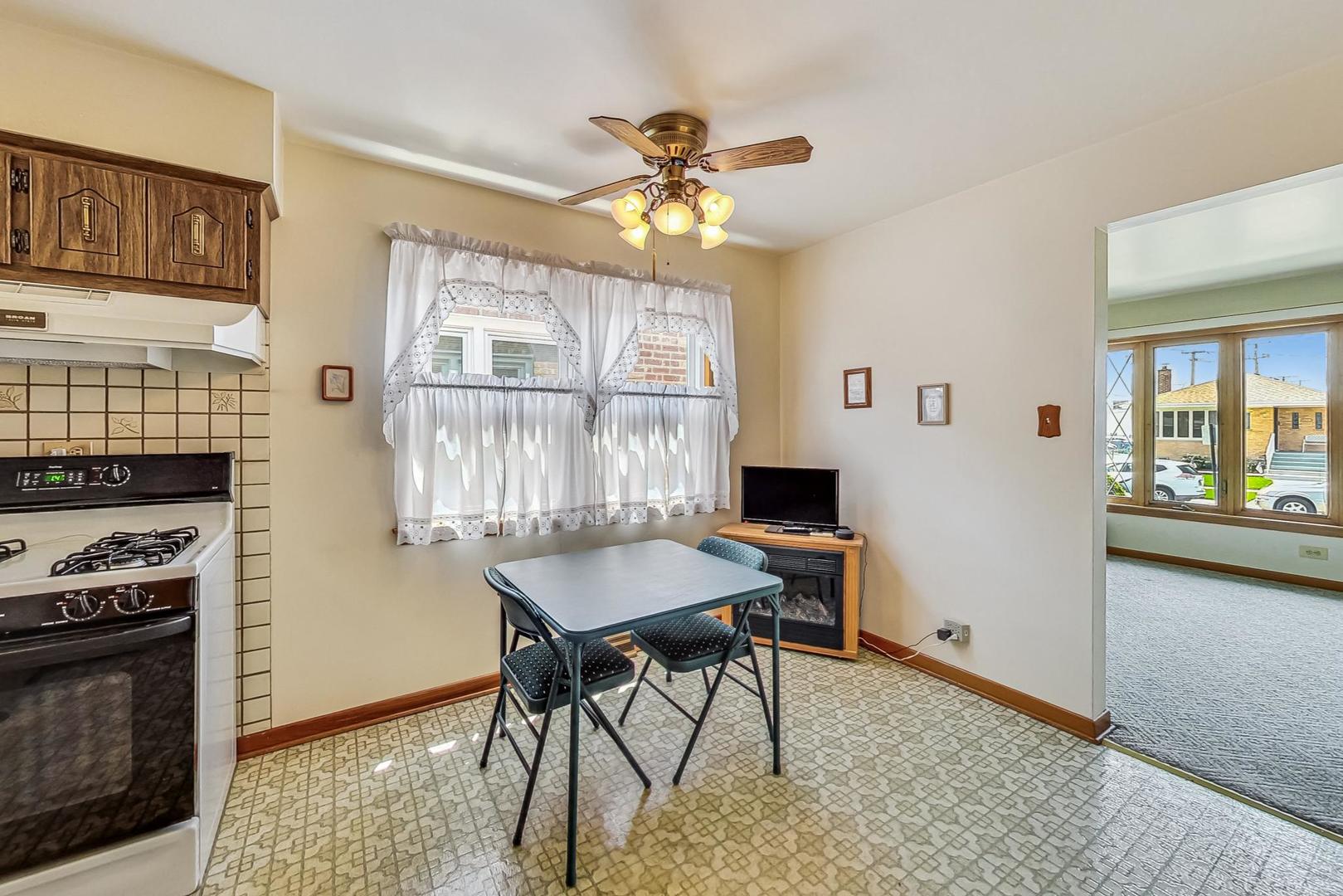 6241 South Rutherford Avenue Chicago, IL 60638 - Photo 9 of 39 a view of a dining room with furniture window and wooden floor