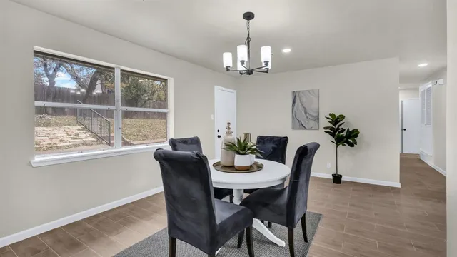 a kitchen with a sink white cabinets and appliances