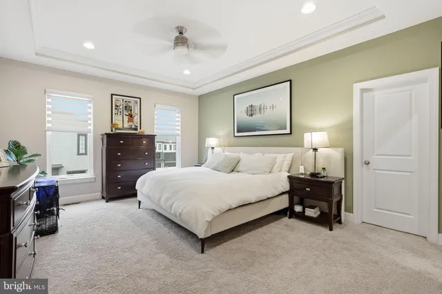 a spacious bedroom with a bed and dresser