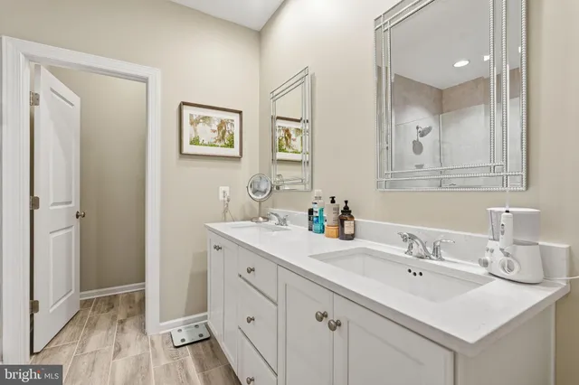 a bathroom with double sink and a mirror
