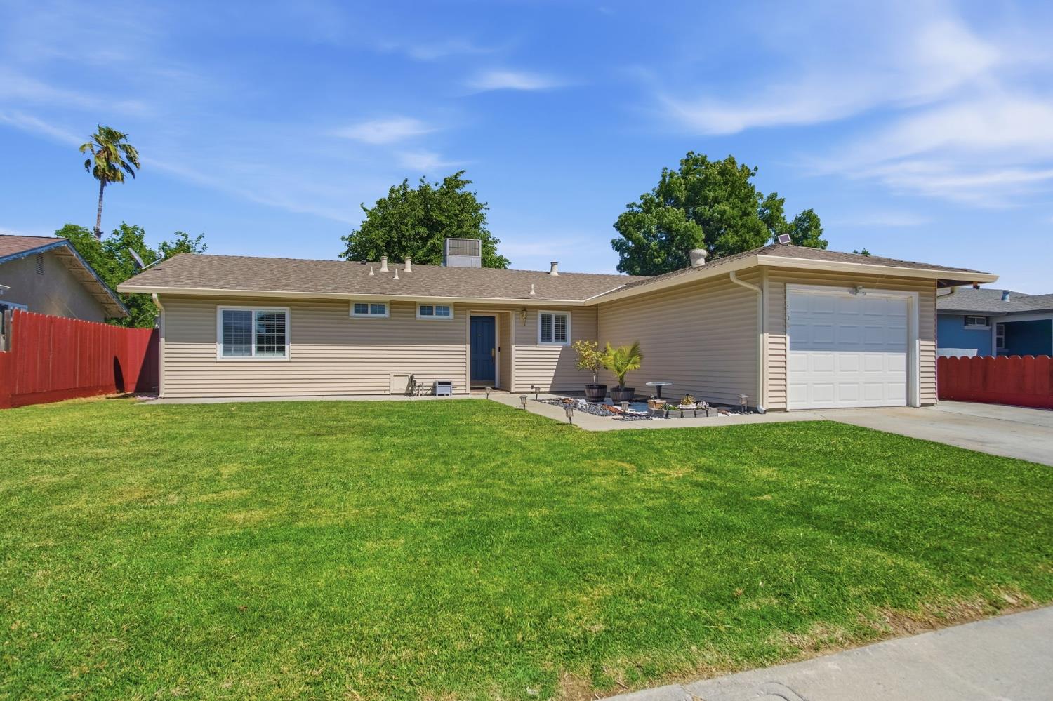 1308 Basil Court Newman, CA 95360 - Photo 3 of 20 a view of a house with backyard and a tree