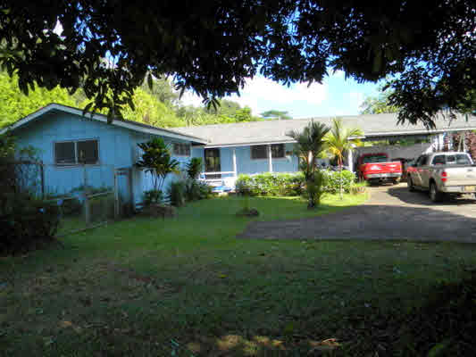 6664 Kuamoo Road Kapaa, HI 96746 - Photo 1 of 15 a front view of a house with a garden and trees