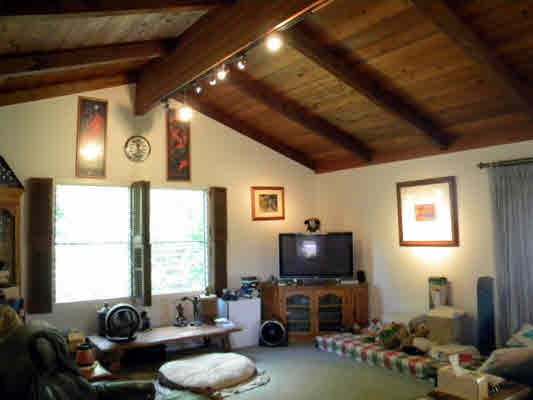 6664 Kuamoo Road Kapaa, HI 96746 - Photo 9 of 15 a living room with furniture a window and a flat screen tv