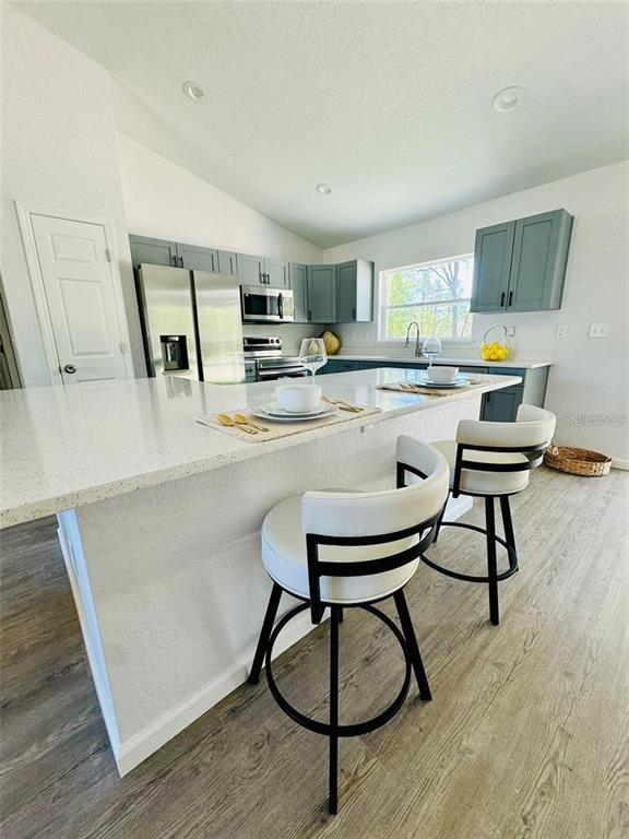 13731 Southwest 89 Circle Ocala, FL 34473 - Photo 11 of 24 a kitchen with a table chairs and a refrigerator