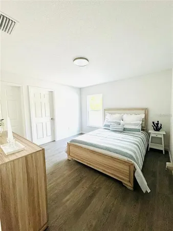 a bedroom with a bed and a table