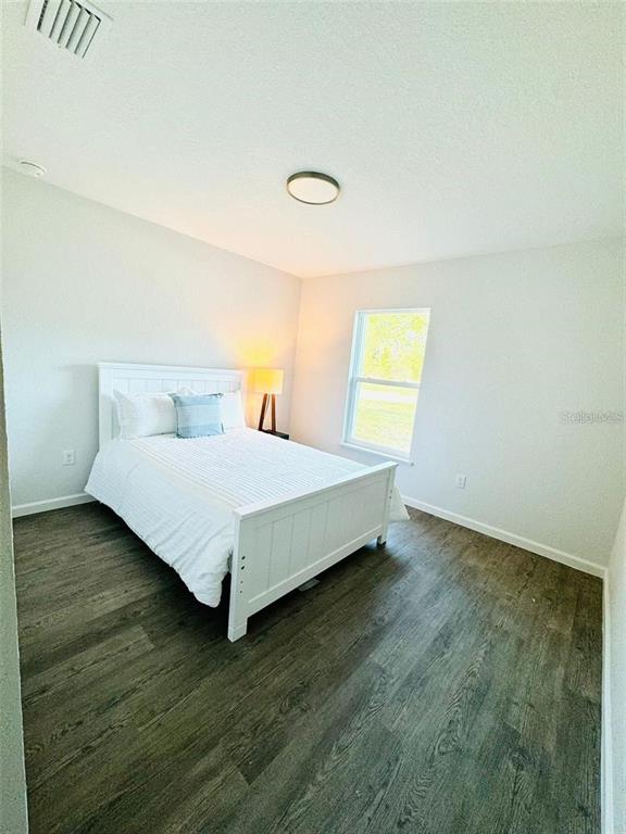 13731 Southwest 89 Circle Ocala, FL 34473 - Photo 15 of 24 a large bed sitting in a room next to a window