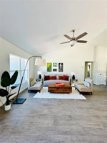 a bedroom with furniture and a wooden floor