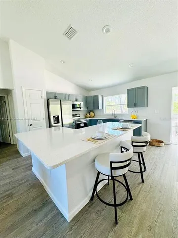 a living room with dining table and wooden floor