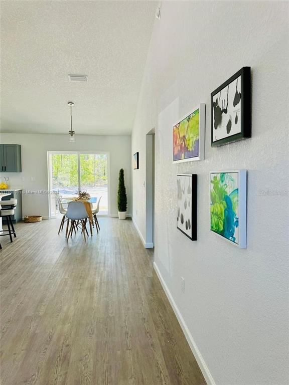 13731 Southwest 89 Circle Ocala, FL 34473 - Photo 19 of 34 a dining room with furniture a floor to ceiling window and potted plants