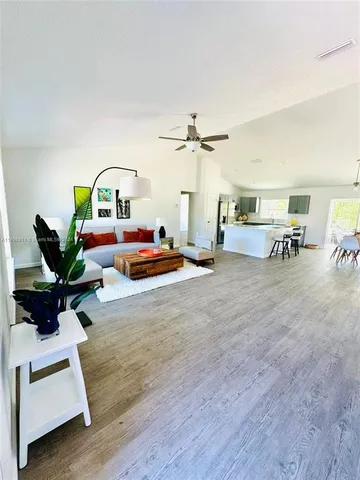 a living room with furniture and a potted plant