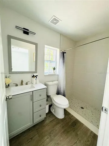 a bathroom with a sink toilet a mirror and shower