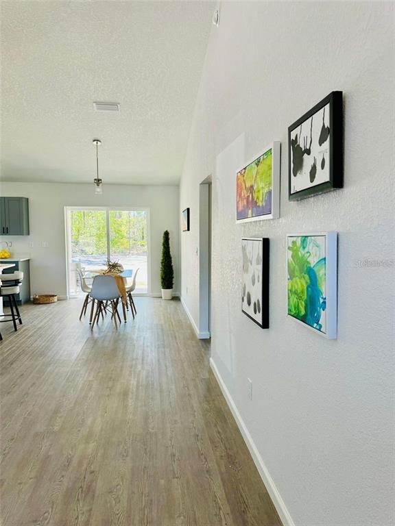 13731 Southwest 89 Circle Ocala, FL 34473 - Photo 5 of 24 a dining room with furniture a floor to ceiling window and potted plants