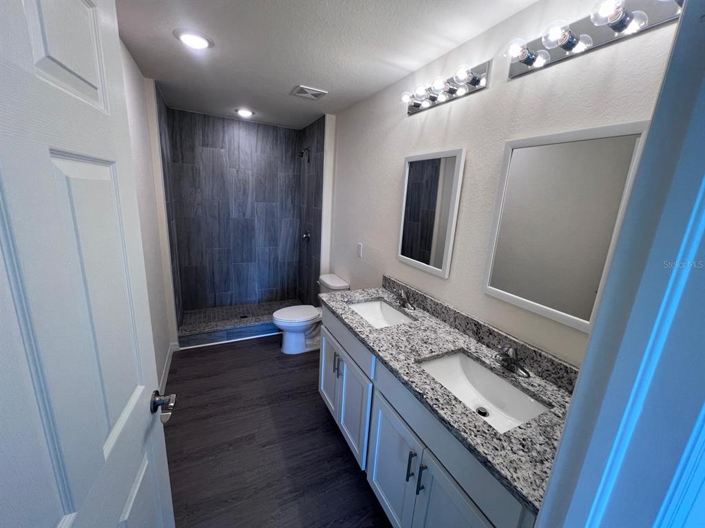 13731 Southwest 89 Circle Ocala, FL 34473 - Photo 6 of 34 a bathroom with double vanity and a mirror