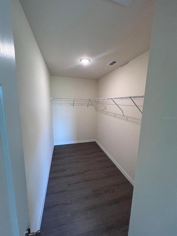13731 Southwest 89 Circle Ocala, FL 34473 - Photo 9 of 34 a view of a hallway with wooden floor