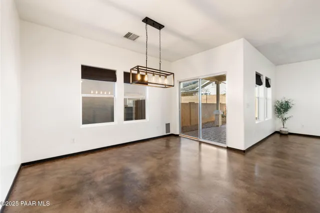 a view of a room with wooden floor and white walls