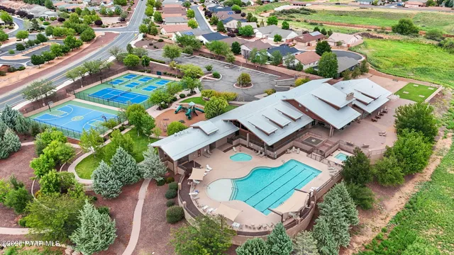 an aerial view of residential houses with outdoor space and ocean view