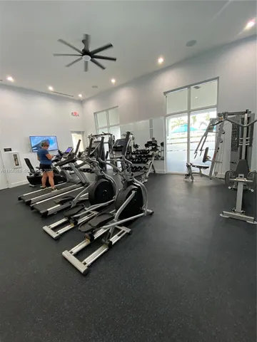 a living room with furniture a flat screen tv and kitchen view