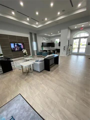 an outdoor sitting area with furniture and garden