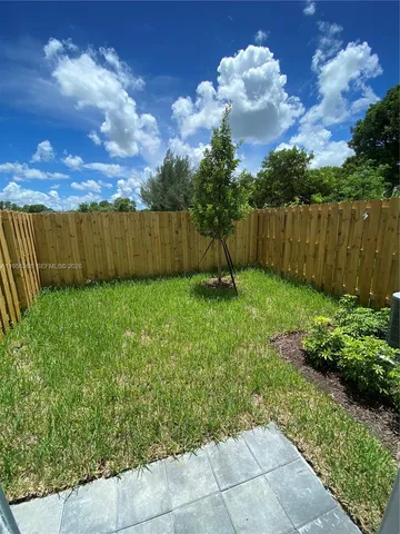 a view of large kitchen with a sink and cabinets