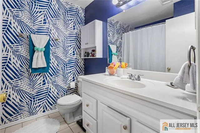 a bathroom with a sink a toilet and mirror