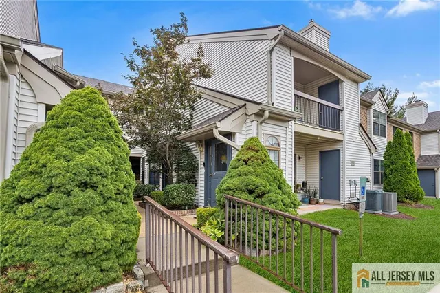 a view of a house with brick walls and potted plants