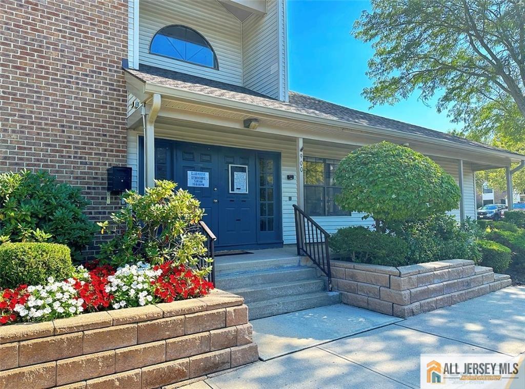 1511 Pebble Place, Unit 1511 Sayreville, NJ 08859 - Photo 23 of 26 a front view of a house with lots of flowers and trees