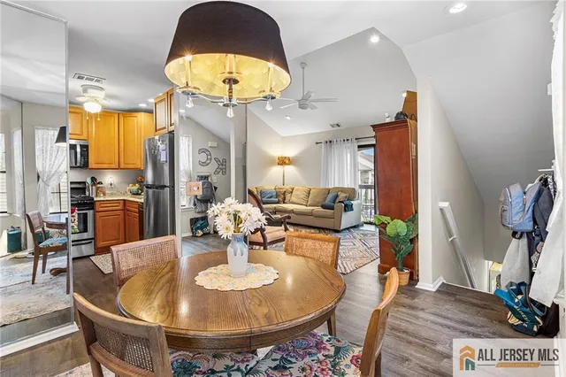 a dining room with furniture and a chandelier