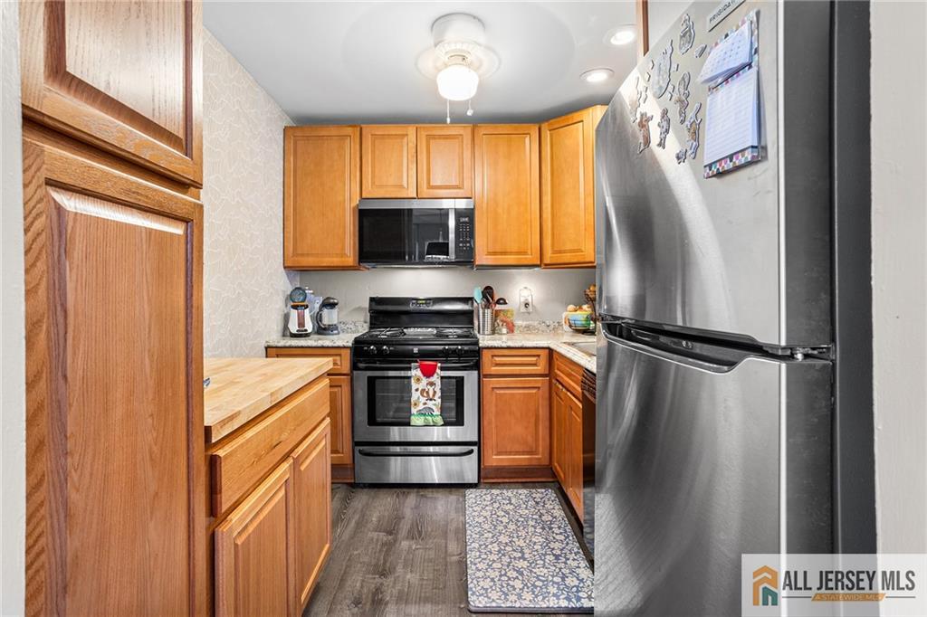 1511 Pebble Place, Unit 1511 Sayreville, NJ 08859 - Photo 6 of 26 a kitchen with stainless steel appliances a refrigerator stove and microwave