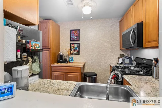 a kitchen with a sink cabinets and appliances