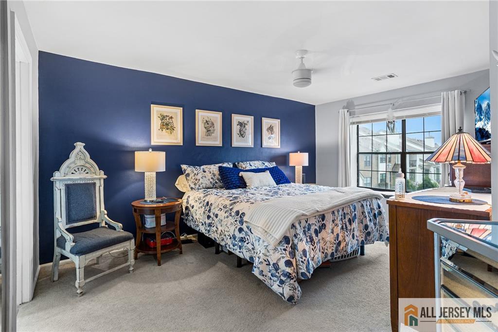 1511 Pebble Place, Unit 1511 Sayreville, NJ 08859 - Photo 9 of 26 a bedroom with a bed and a table