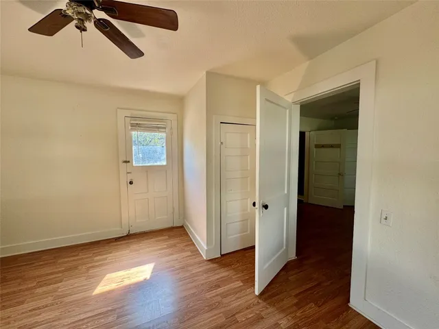a view of an empty room with wooden floor