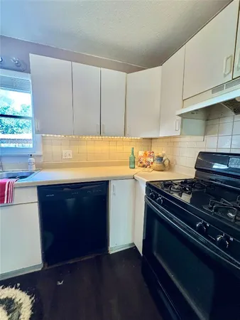a kitchen with a stove and a microwave