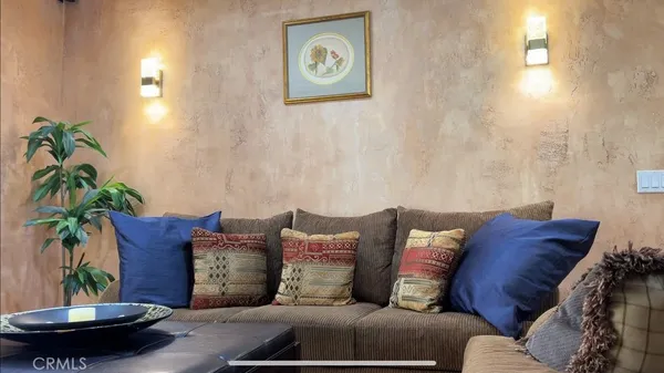 a living room with furniture and a potted plant