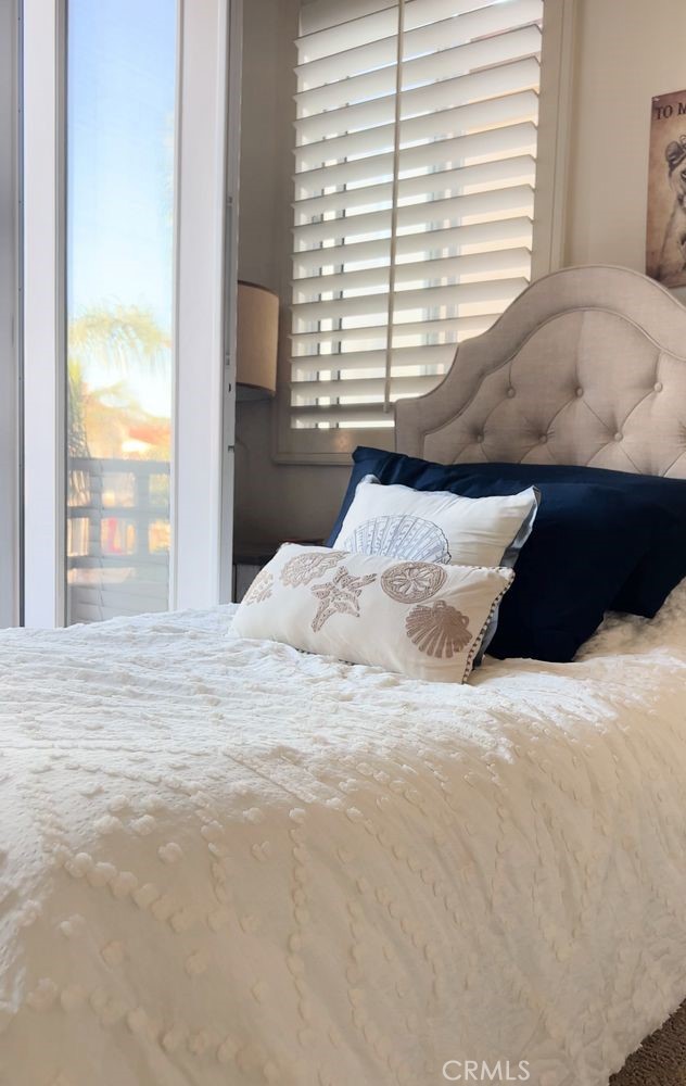 609 21st Street Huntington Beach, CA 92648 - Photo 4 of 8 a bedroom with a bed and a large window