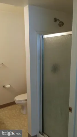 a bathroom with a toilet and a shower