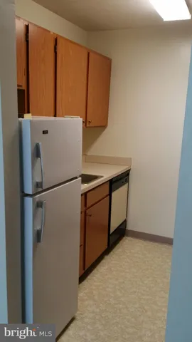 a white refrigerator freezer sitting in a kitchen