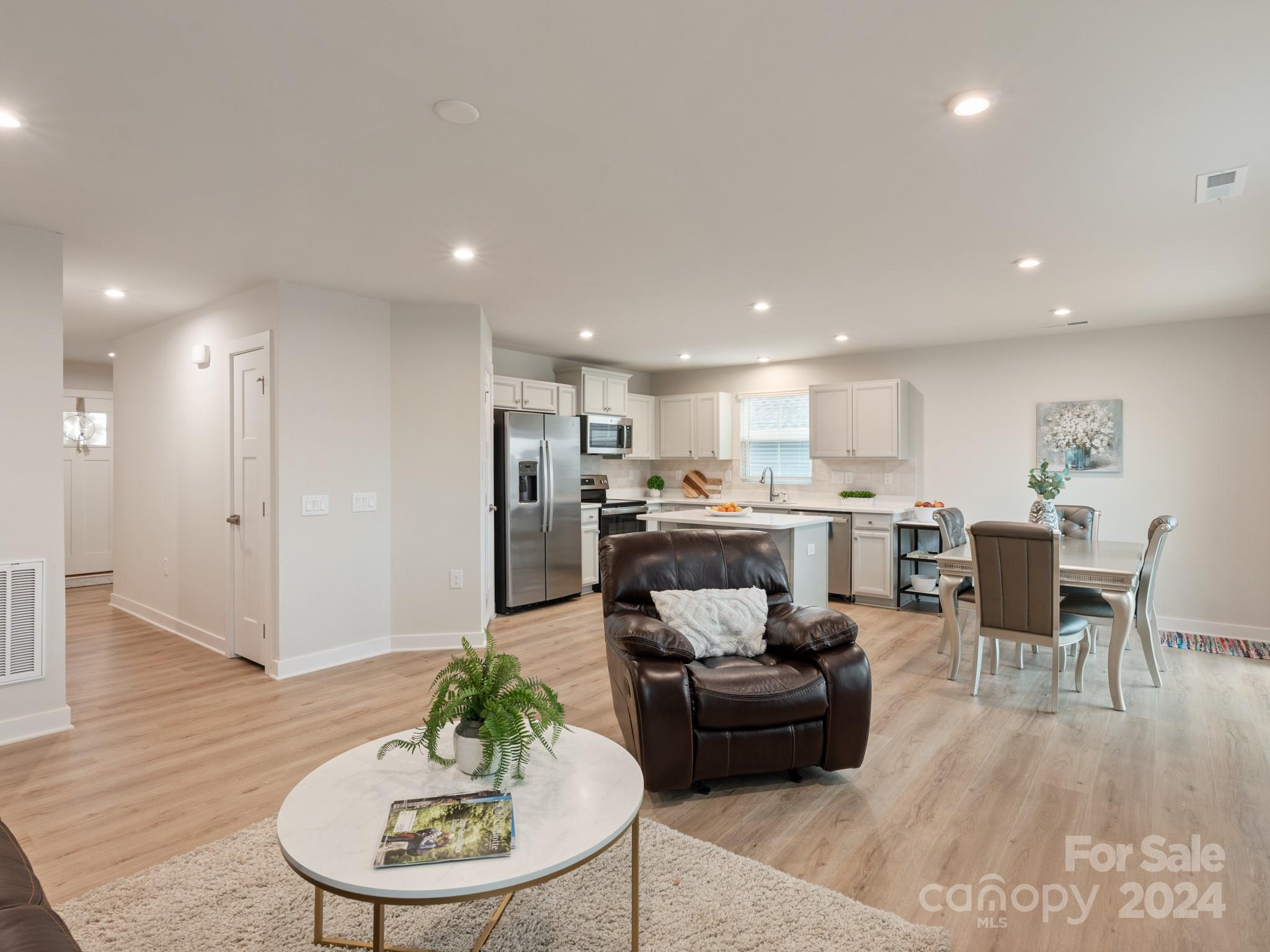 309 Damask Drive Lancaster, SC 29720 - Photo 12 of 28 a living room with stainless steel appliances kitchen island granite countertop a dining table chairs and a kitchen view