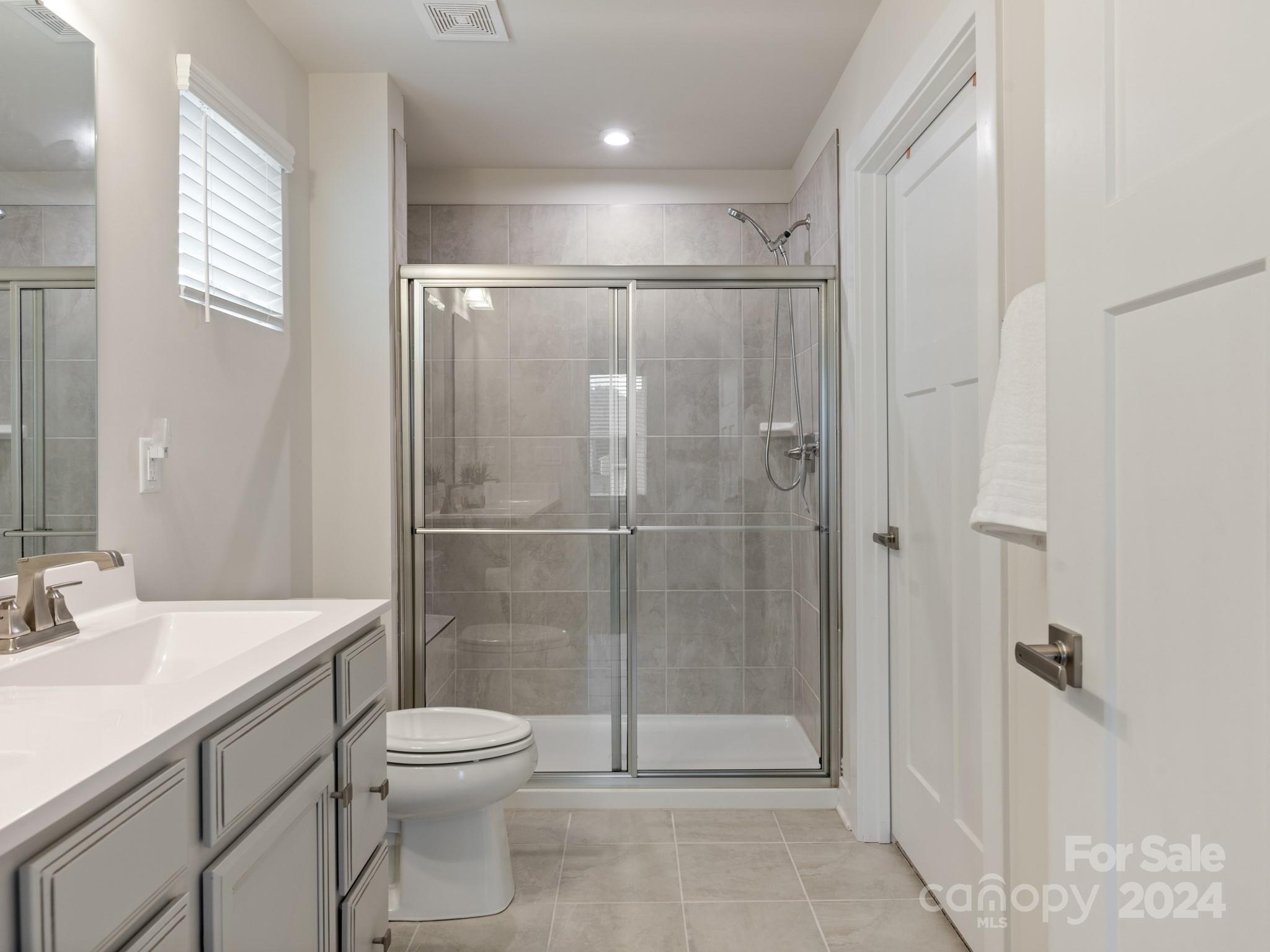 309 Damask Drive Lancaster, SC 29720 - Photo 17 of 28 a bathroom with a shower a toilet and a sink