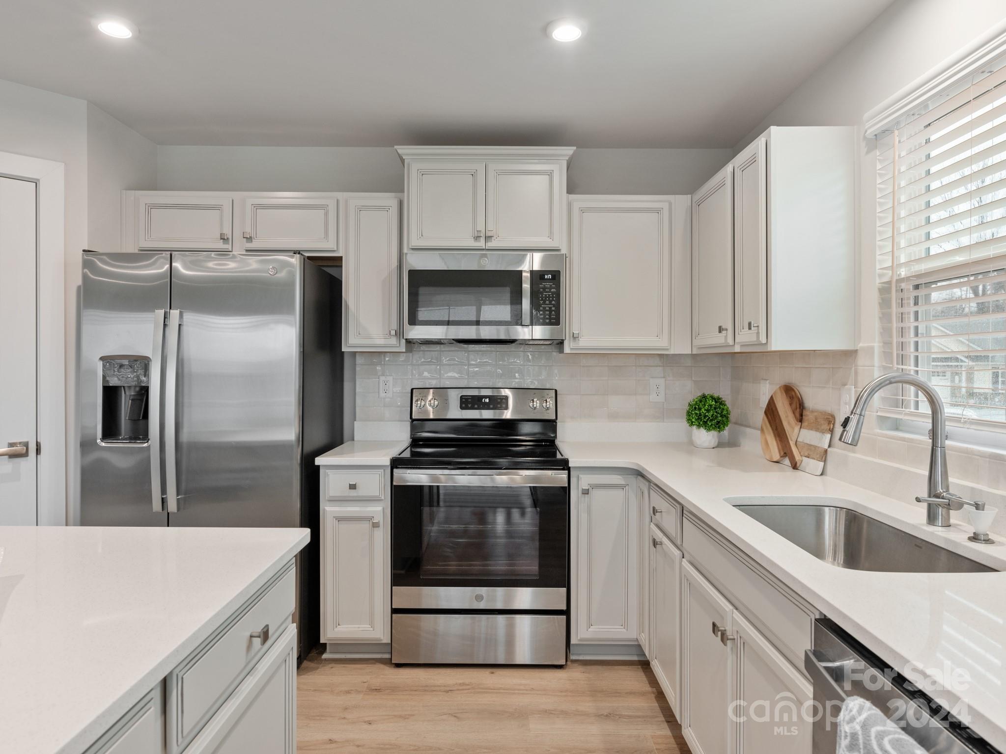 309 Damask Drive Lancaster, SC 29720 - Photo 3 of 28 a kitchen with a sink stove and refrigerator