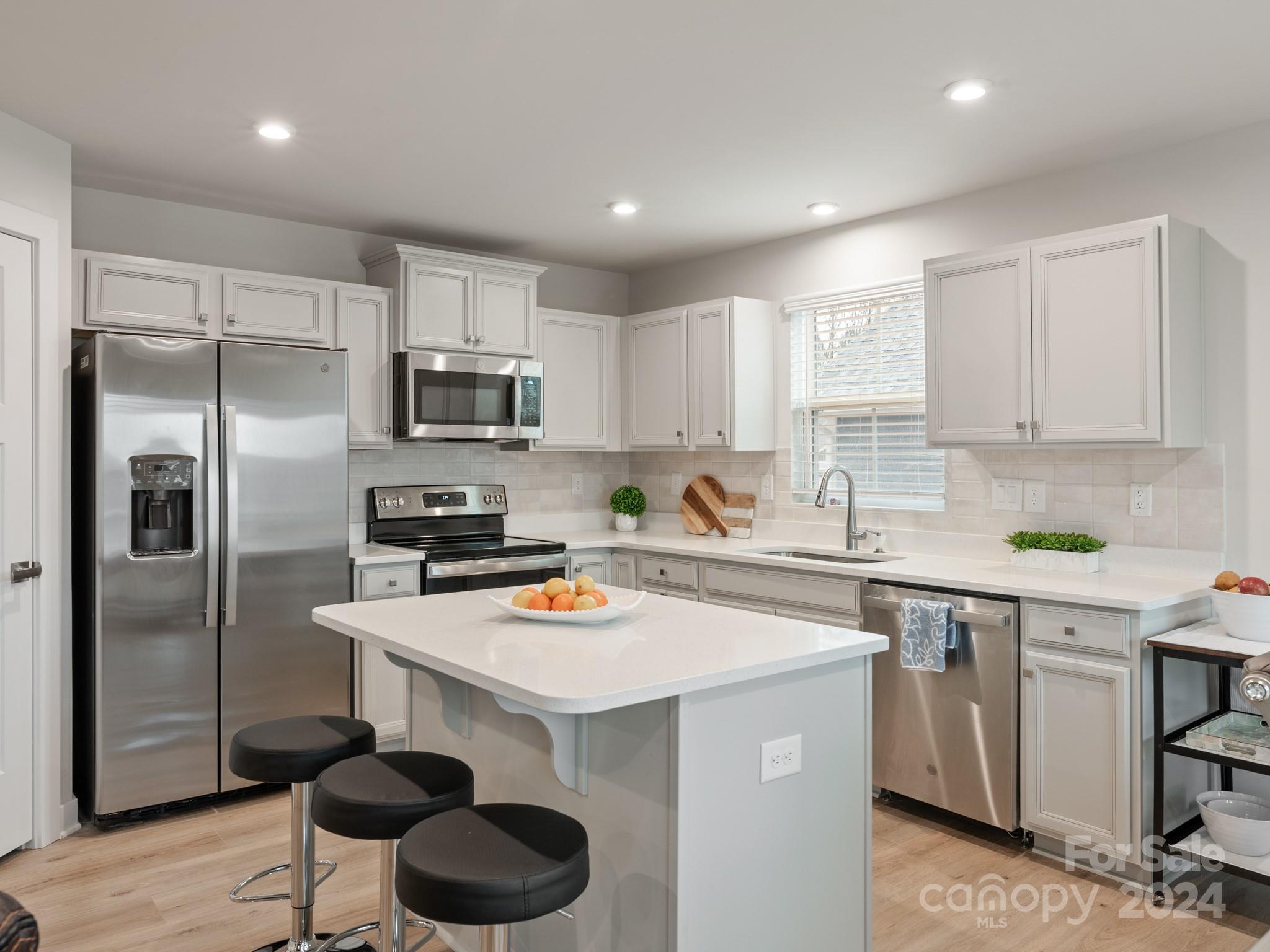 309 Damask Drive Lancaster, SC 29720 - Photo 5 of 28 a kitchen with a sink a stove and refrigerator