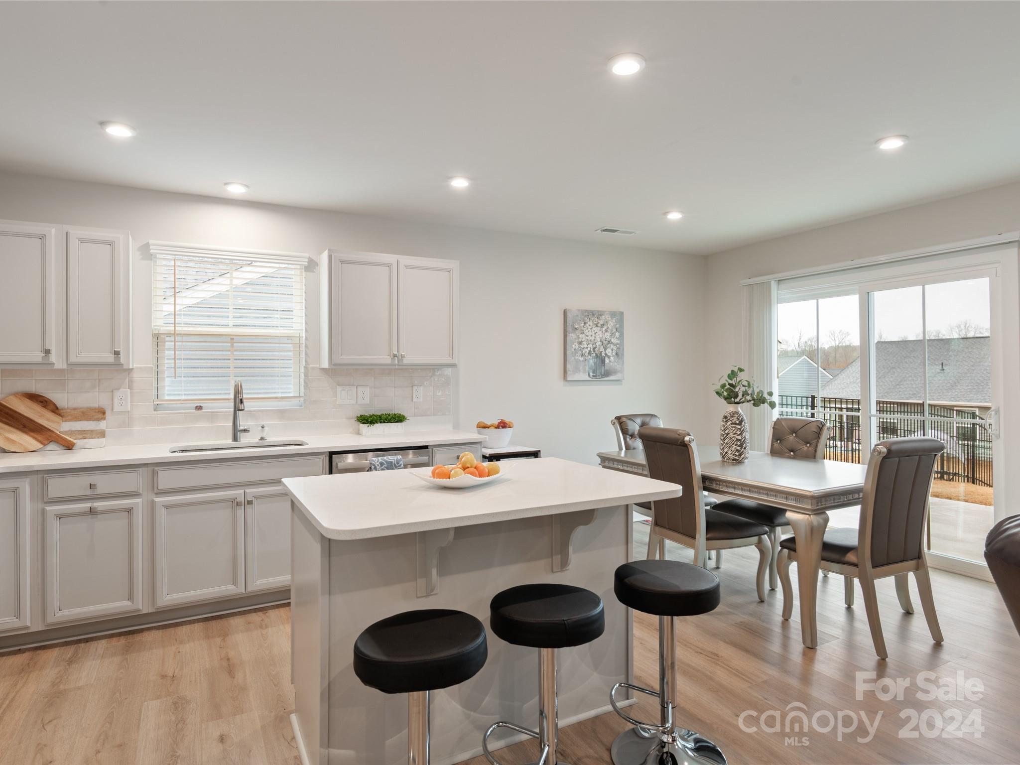 309 Damask Drive Lancaster, SC 29720 - Photo 6 of 28 a kitchen with a dining table chairs and white appliances
